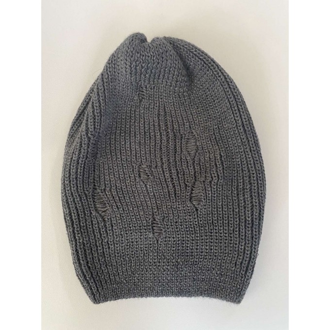 Thin knitted beanie hat with a pattern of dropped loops that create a "hole effect". merino wool and polyamide